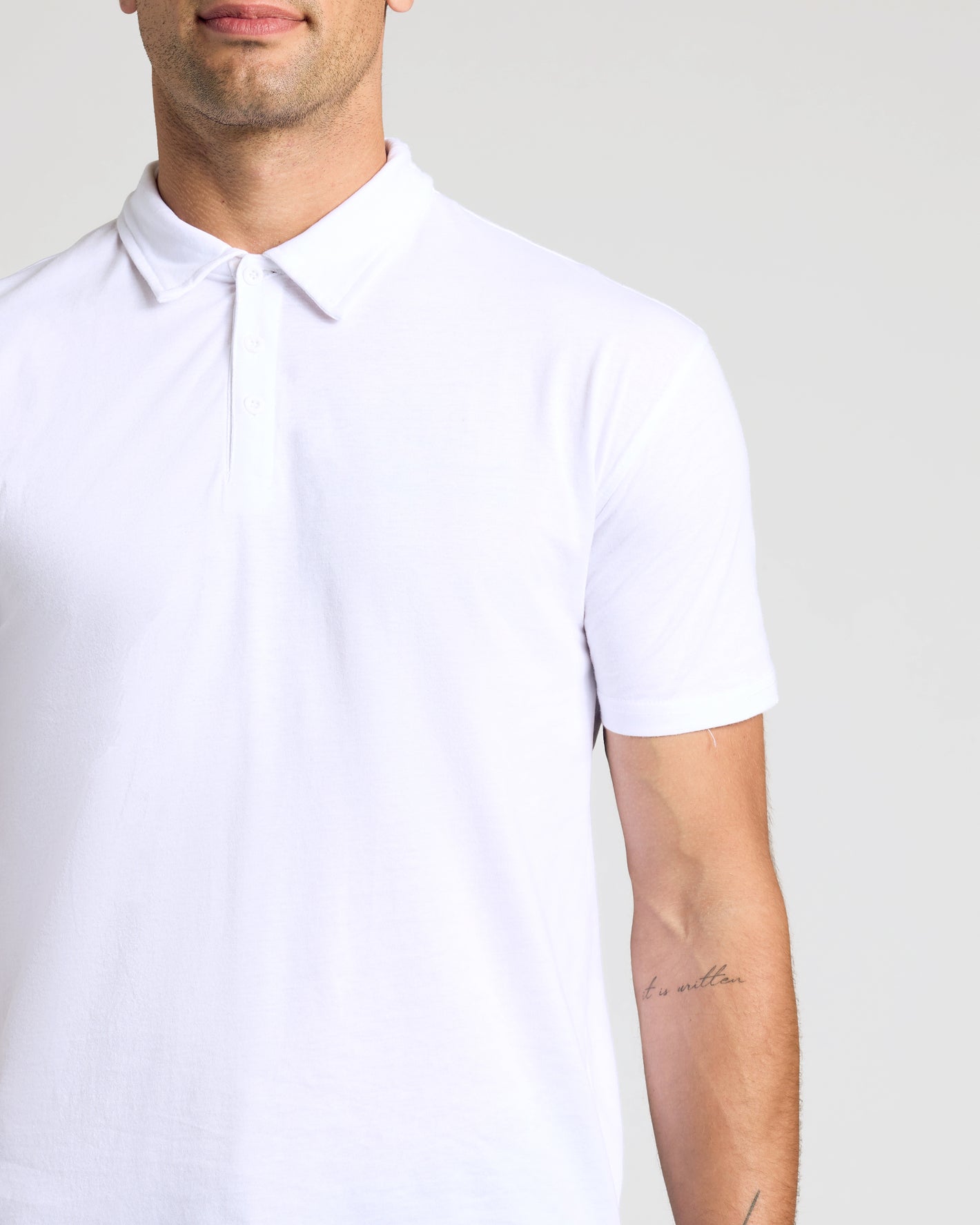 Man wearing All White Classic Polo from 10-Pack, featuring a three-button placket.