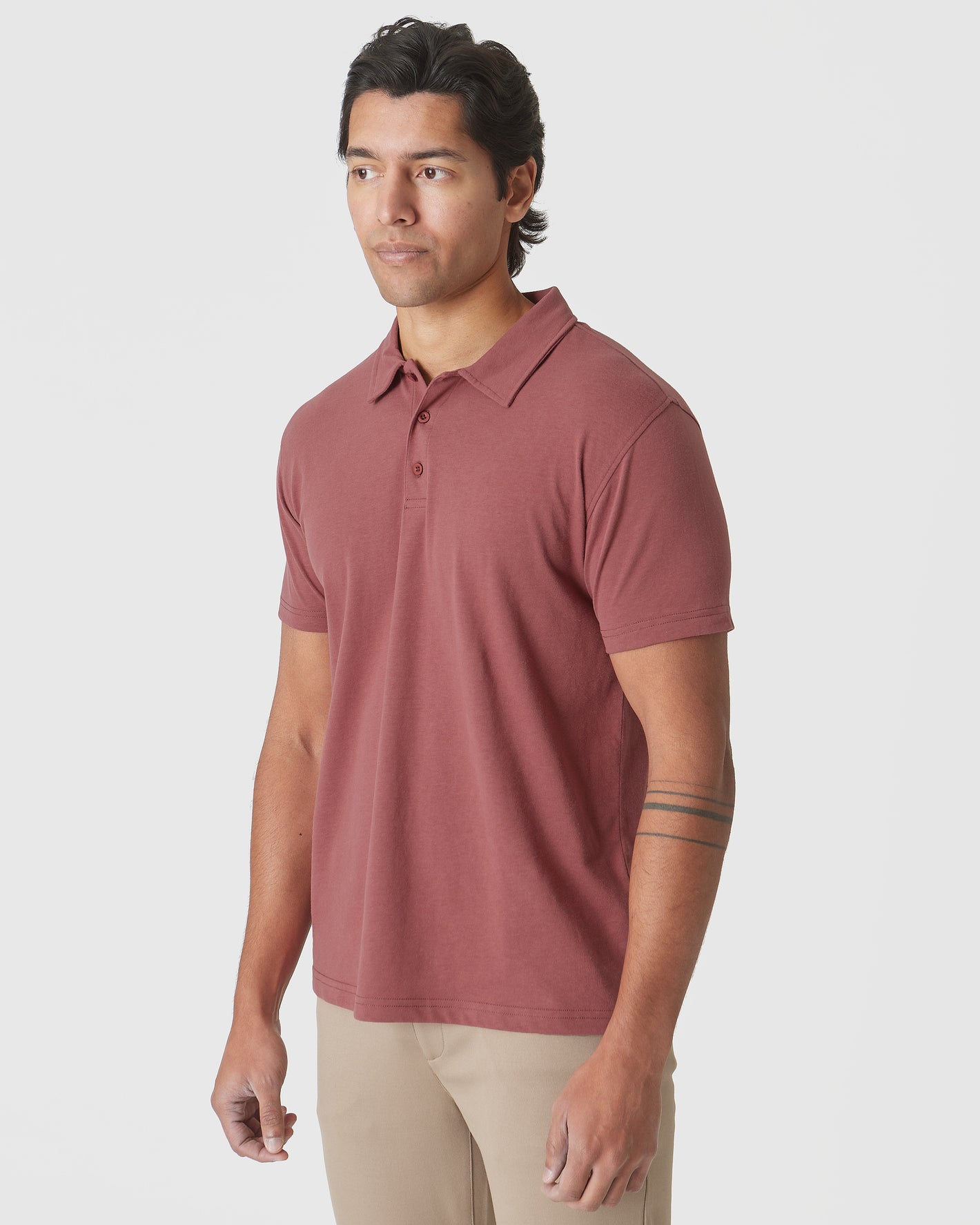 Man wearing Rustic Apple Polo with tan pants.