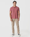 Man wearing Rustic Apple Polo, tan pants, black sneakers.