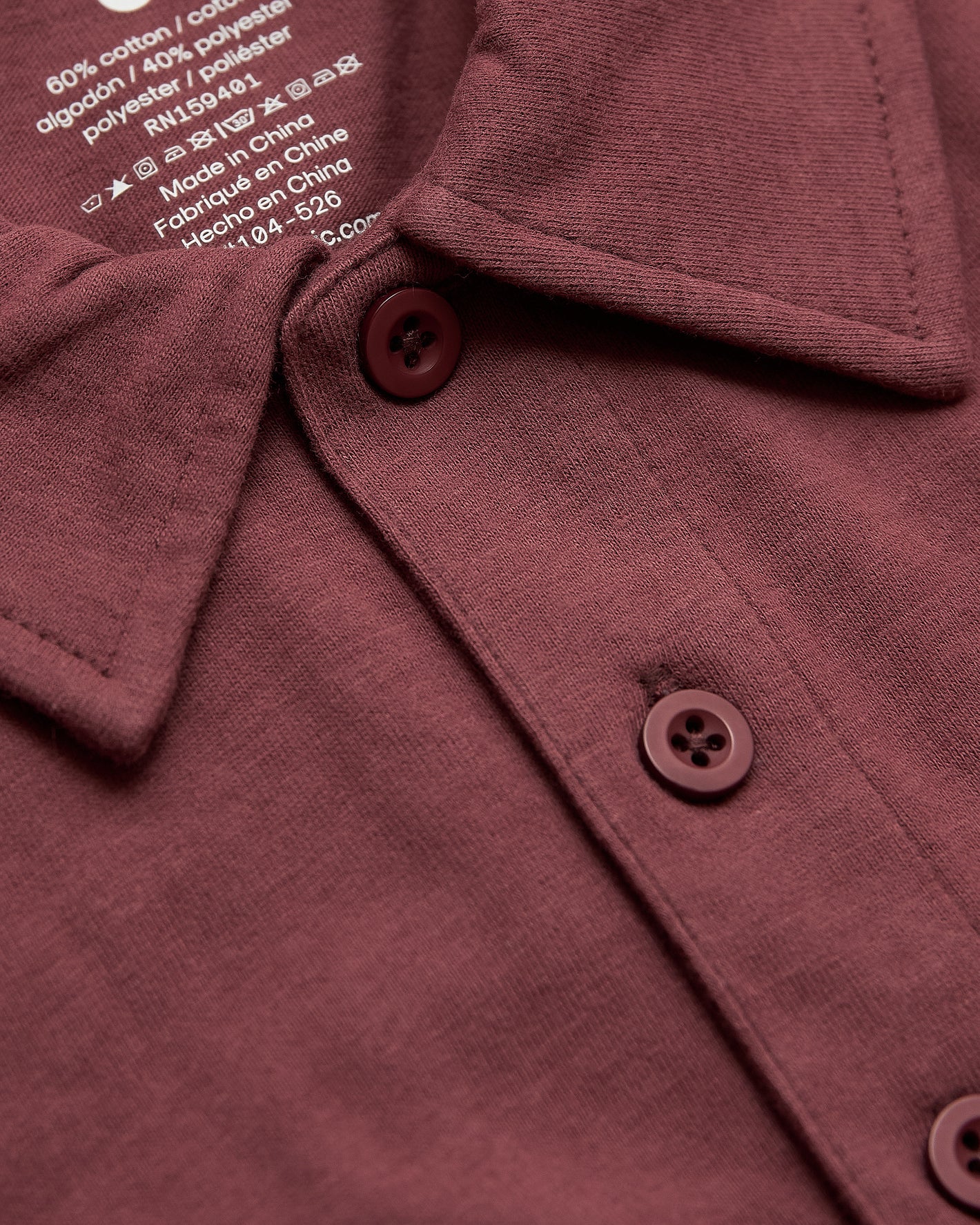 Rustic Apple Polo with folded collar and two-button placket.
