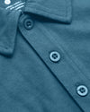 Sapphire Classic Polo close-up: folded collar, three-button placket, care label.