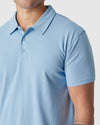 Sky Blue Heather Polo with classic collar and two buttons, worn by model.