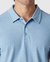Sky Blue Heather Polo with a two-button placket and flat collar.