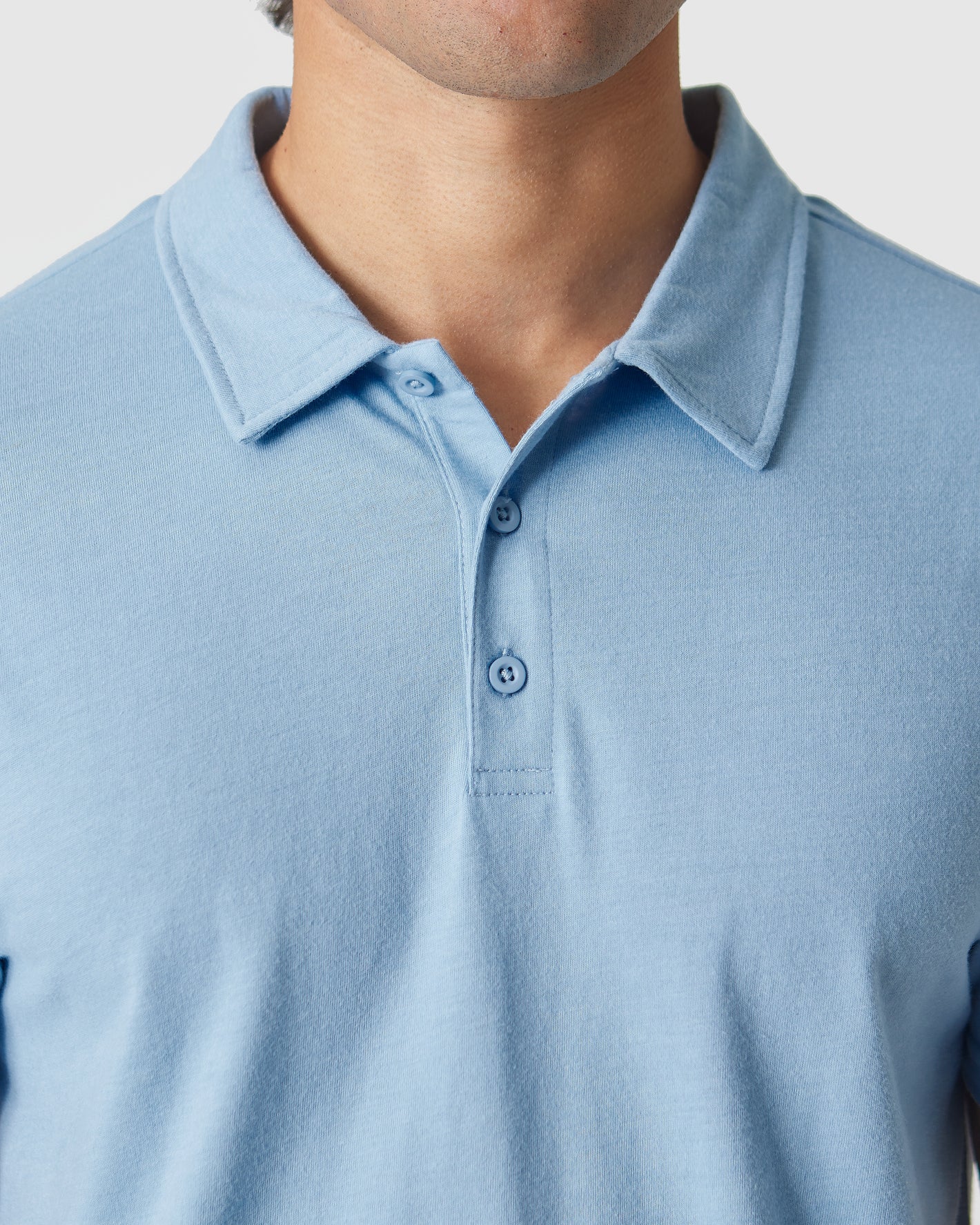 Sky Blue Heather Polo with a two-button placket and flat collar.