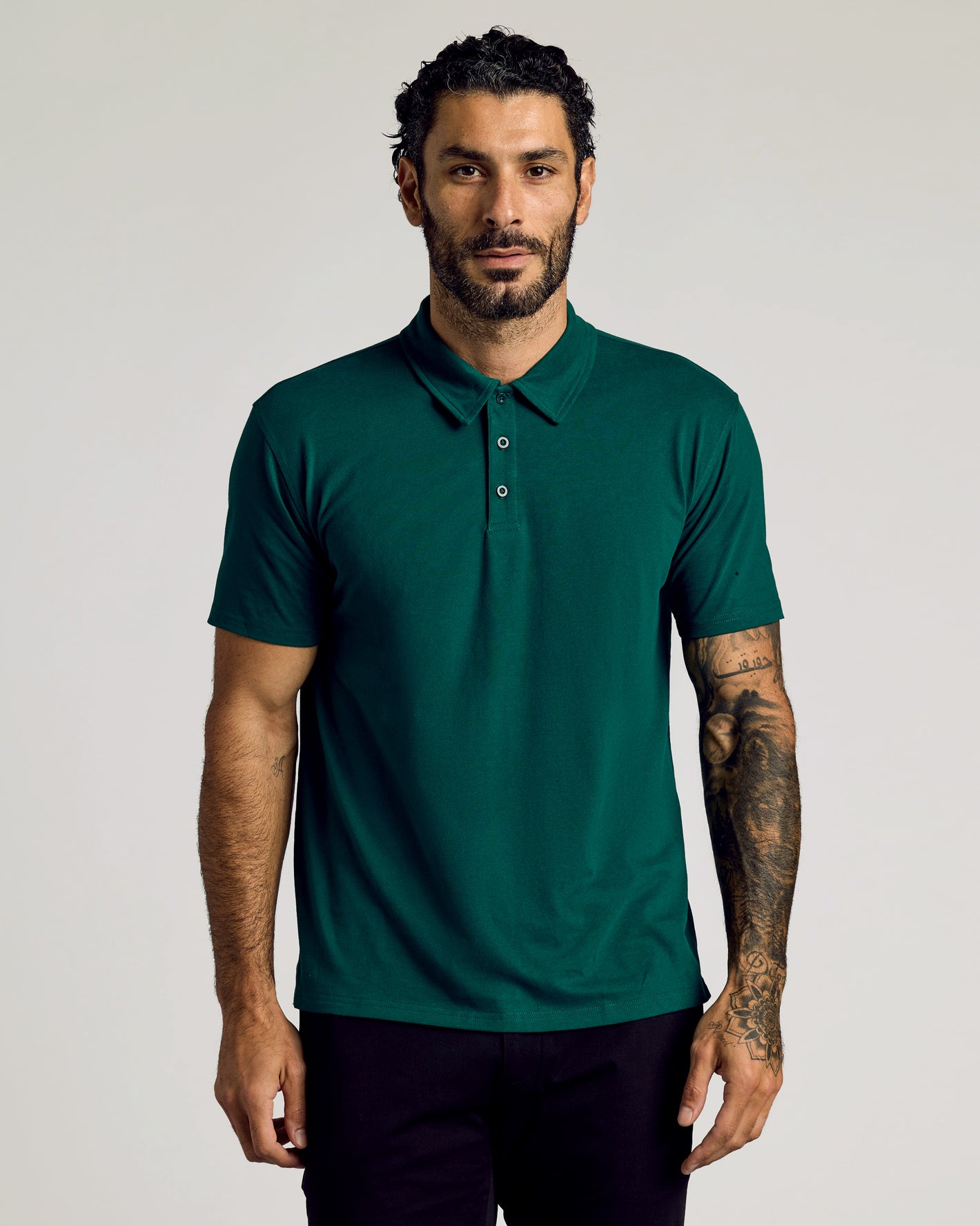 Viridian Classic Polo worn by tattooed man, neutral expression.
