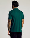 Man in Viridian Classic Polo with floral tattoo sleeve.