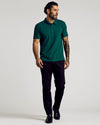 Viridian Classic Polo on tattooed man, styled with black trousers.