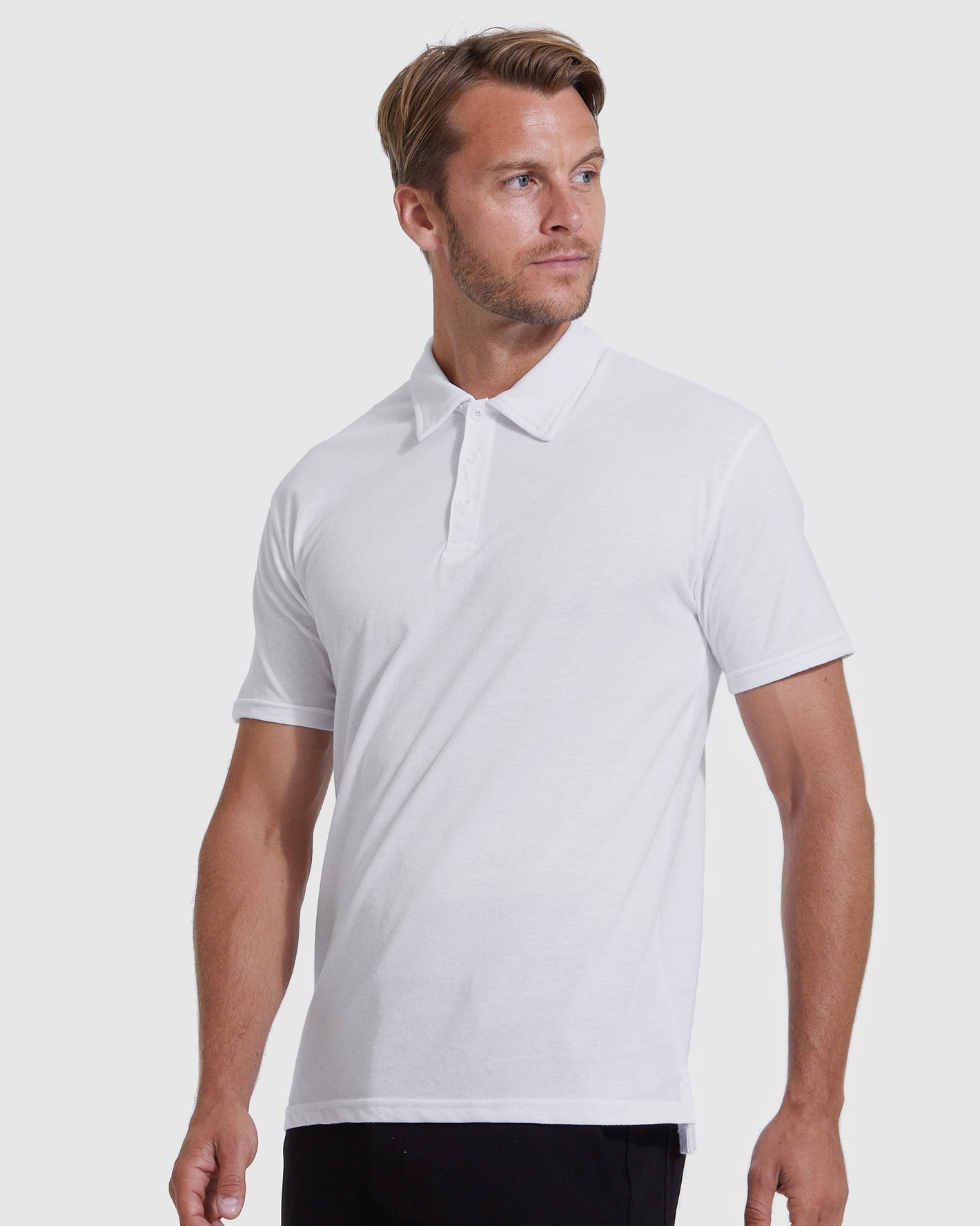 White Classic Polo 6-Pack on male model, relaxed stance, neutral backdrop.