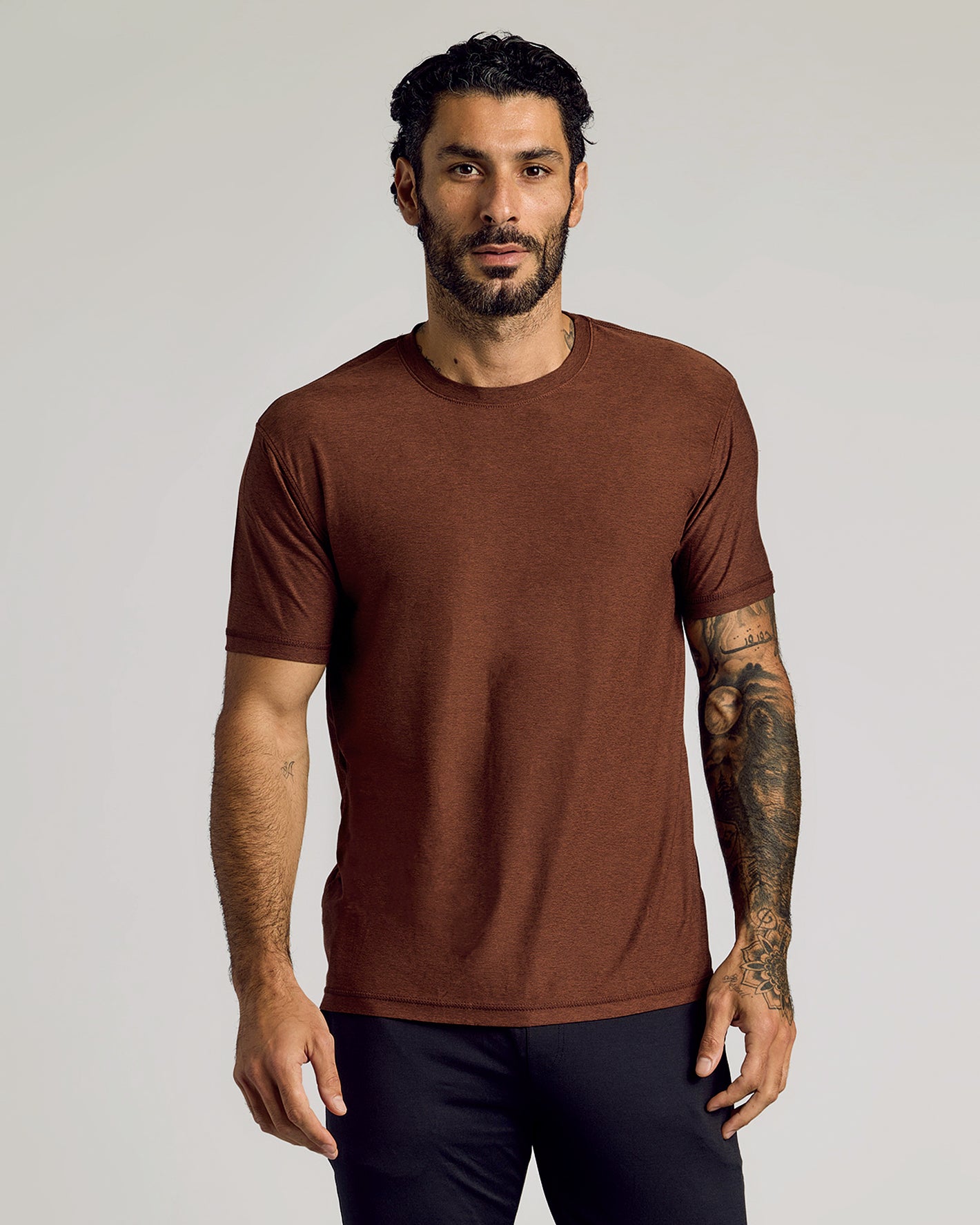 Man wearing Cedar Active Short Sleeve Crew Neck Tee with tattoos on right arm.