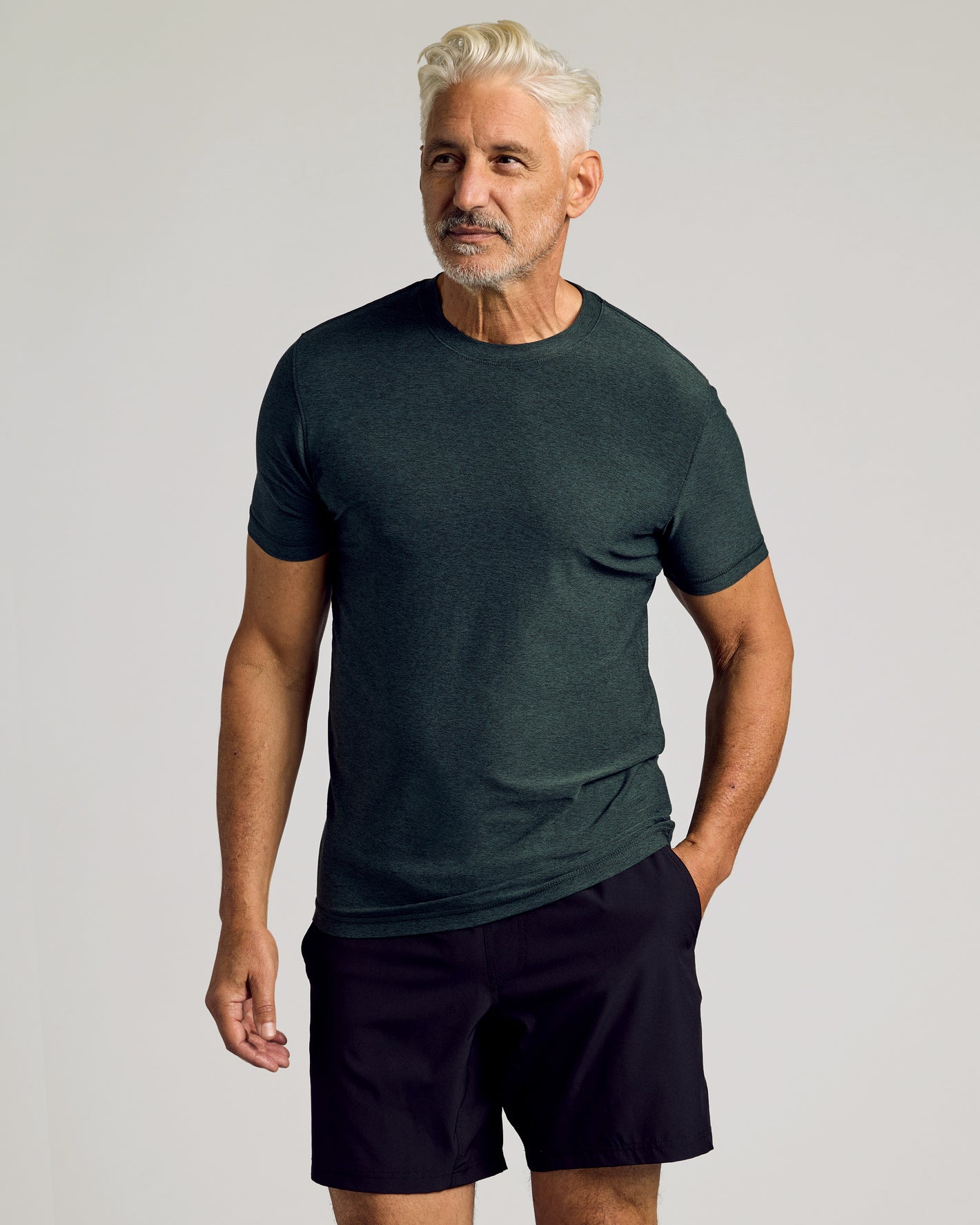 Man wearing Dark Heather Forest Active Short Sleeve Crew Neck Tee.