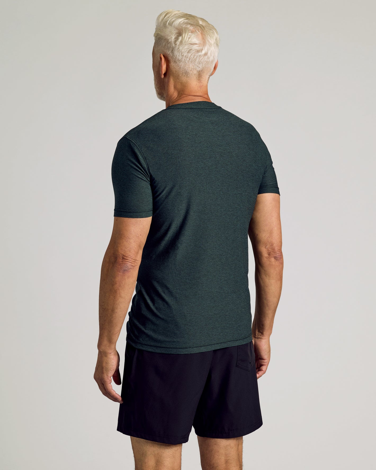 Dark Heather Forest Active Short Sleeve Crew Neck Tee on male model's back view.