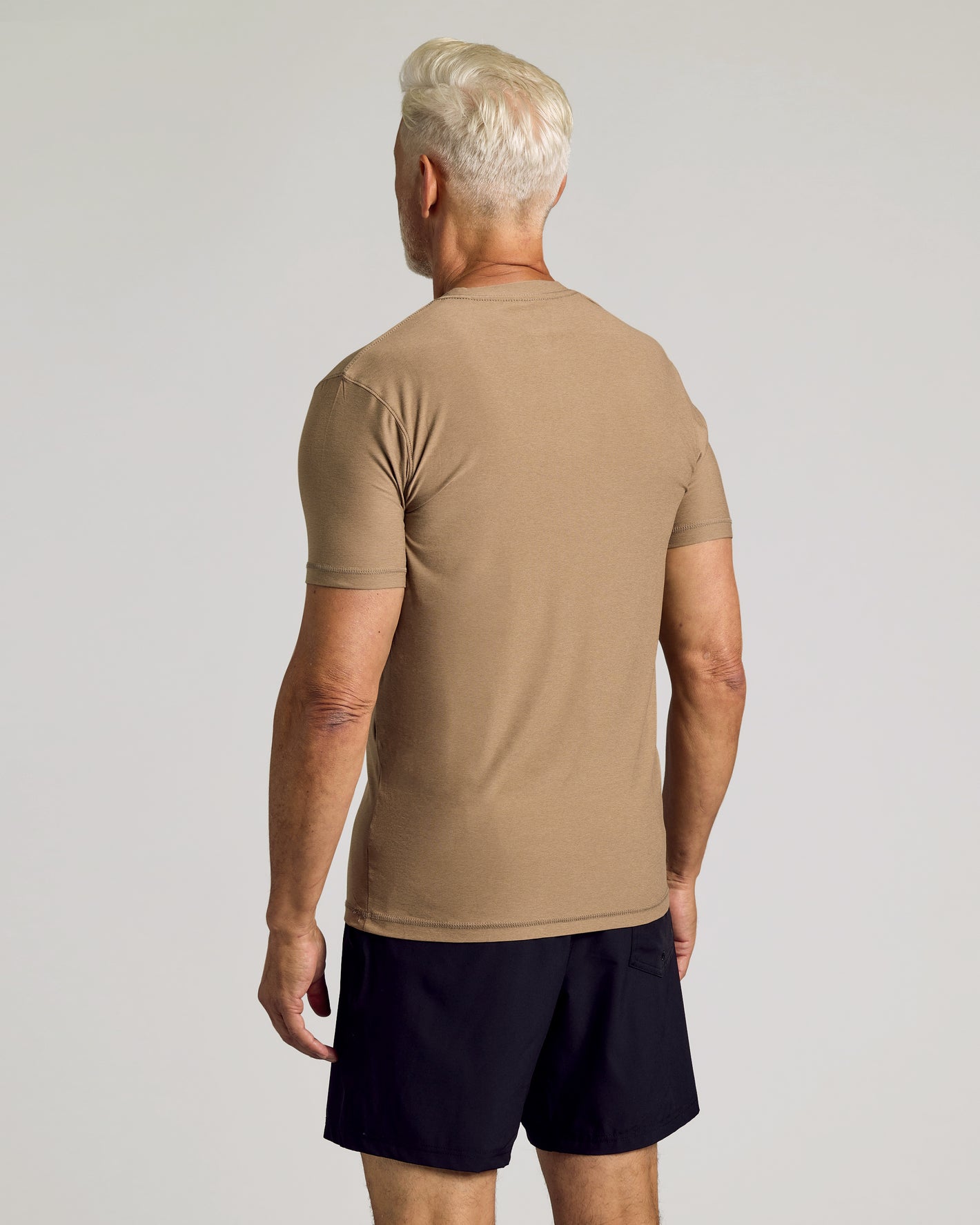 Driftwood Active Crew Neck Tee, rear view on model, studio setting.