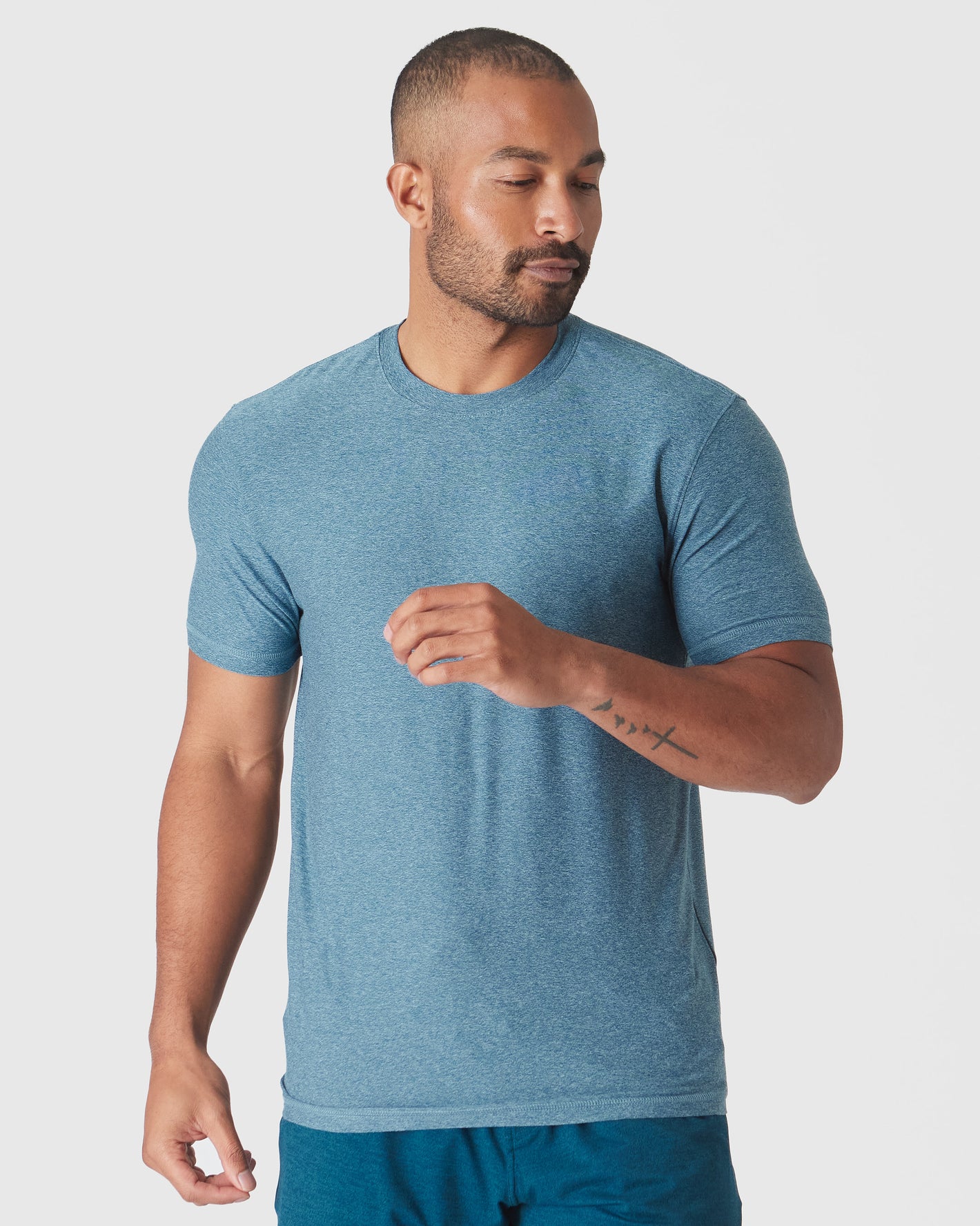 Man in Heather Centurion Short Sleeve Active Crew Neck, relaxed pose.