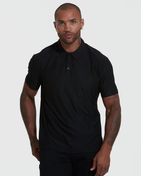 Man wearing Active Short Sleeve Polo, showcasing fit and tattoos.