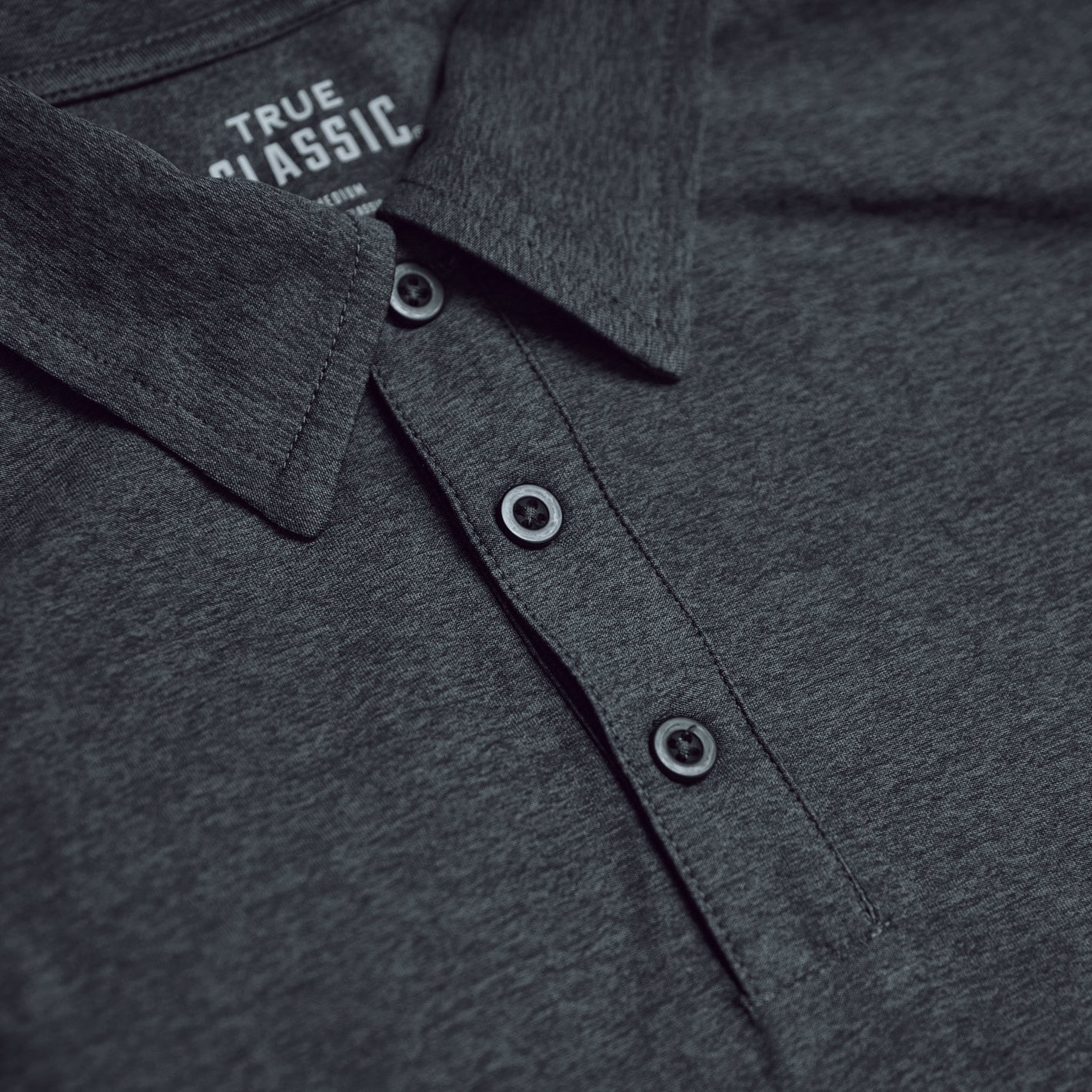Charcoal Heather Gray Active Polo 2.0 showcasing collar and three-button placket.