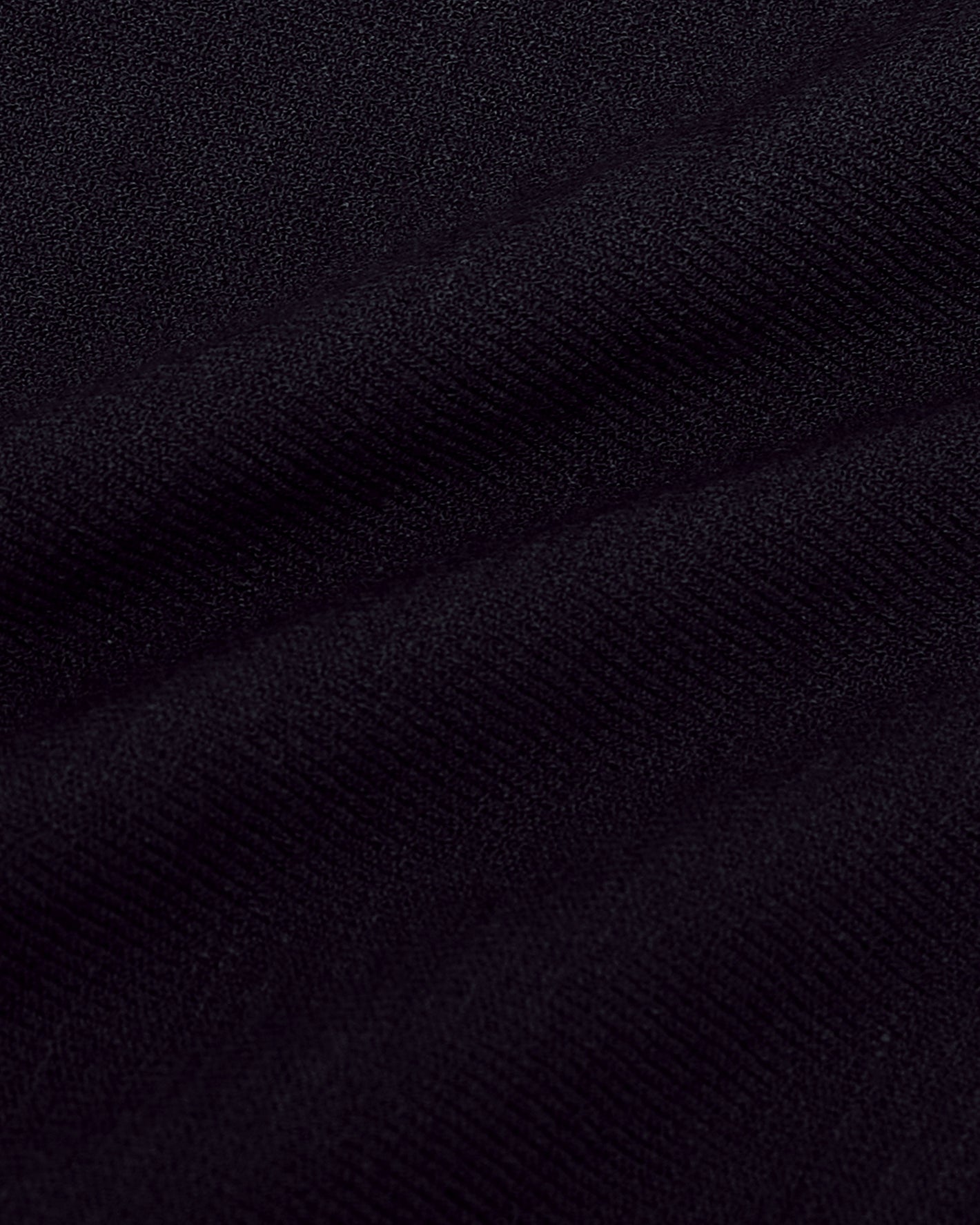 Black Short Sleeve Sweater Polo displaying soft, woven texture and gentle drape.