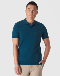 True ClassicMan wearing Centurion Short Sleeve Sweater Polo in teal with beige trousers.