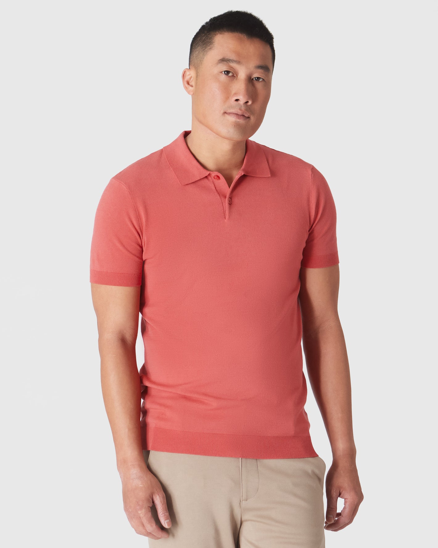 Garnet Short Sleeve Sweater Polo on male model with khaki trousers.