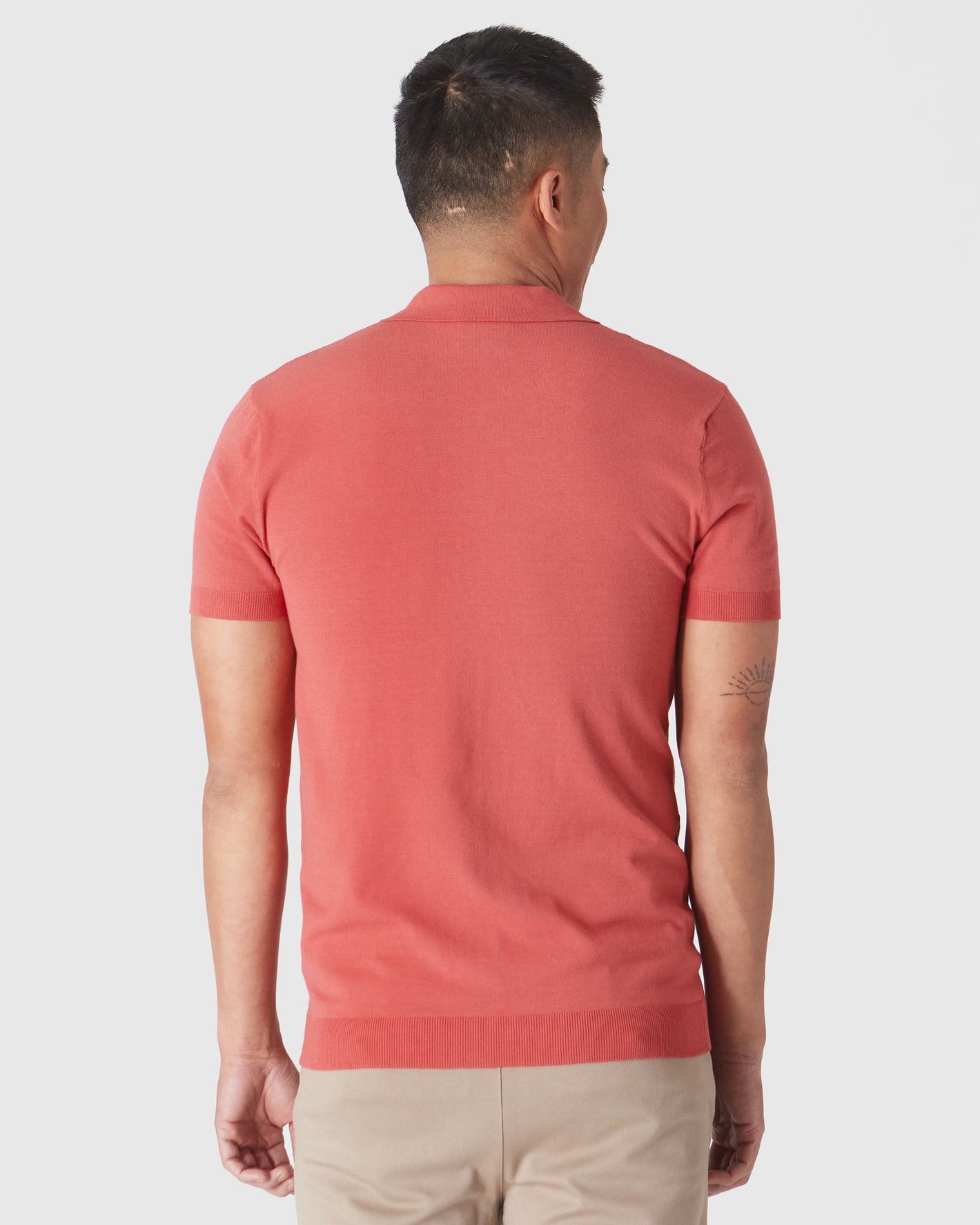 Back view of man in Garnet Short Sleeve Sweater Polo.