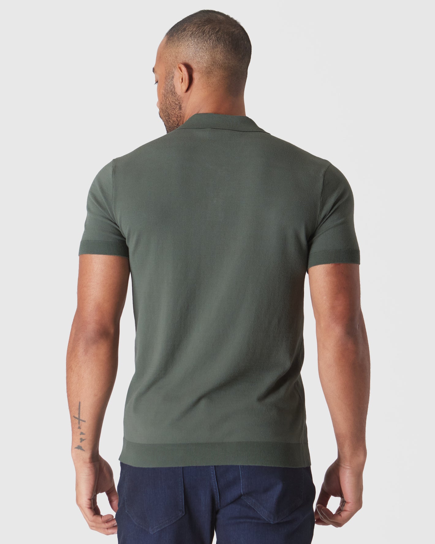 Back view of man in Moss Short Sleeve Sweater Polo.