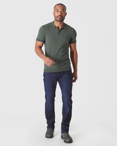 True ClassicModel wearing Moss Short Sleeve Sweater Polo, dark jeans, gray Chelsea boots.