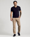 Man wearing Black Short Sleeve Sweater Polo with tan trousers.