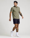 Model in olive polo from Polos Variety 4-Pack, tattoos visible.