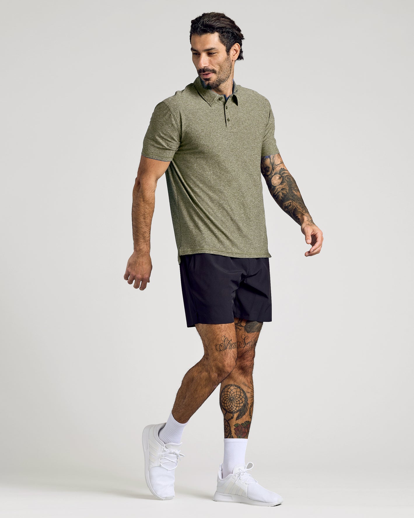 Model in olive polo from Polos Variety 4-Pack, tattoos visible.