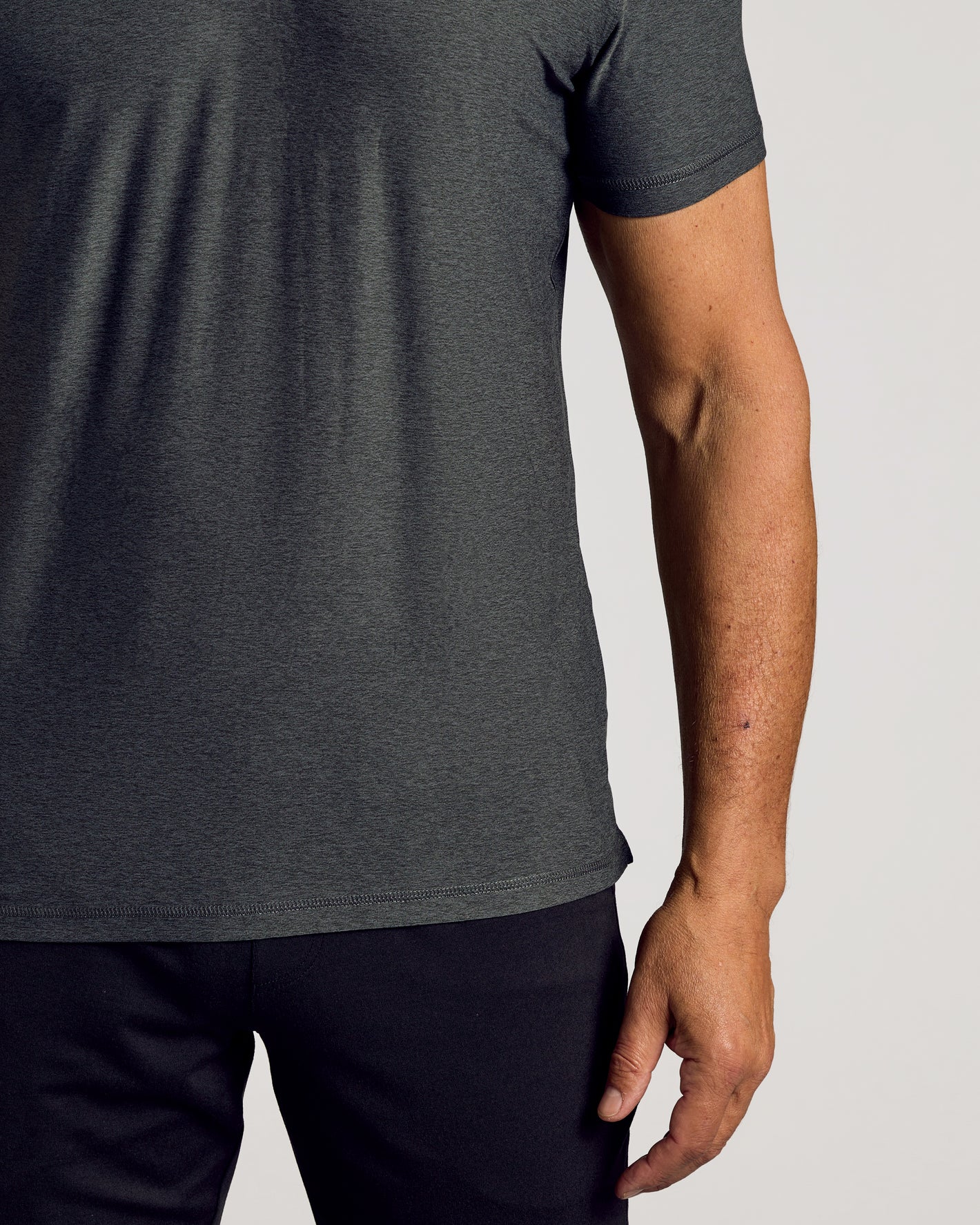 Charcoal Heather Gray Active Polo 2.0 on torso and arm.