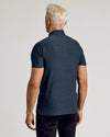 Back view of man wearing Dark Heather Fiord Active Polo 2.0.