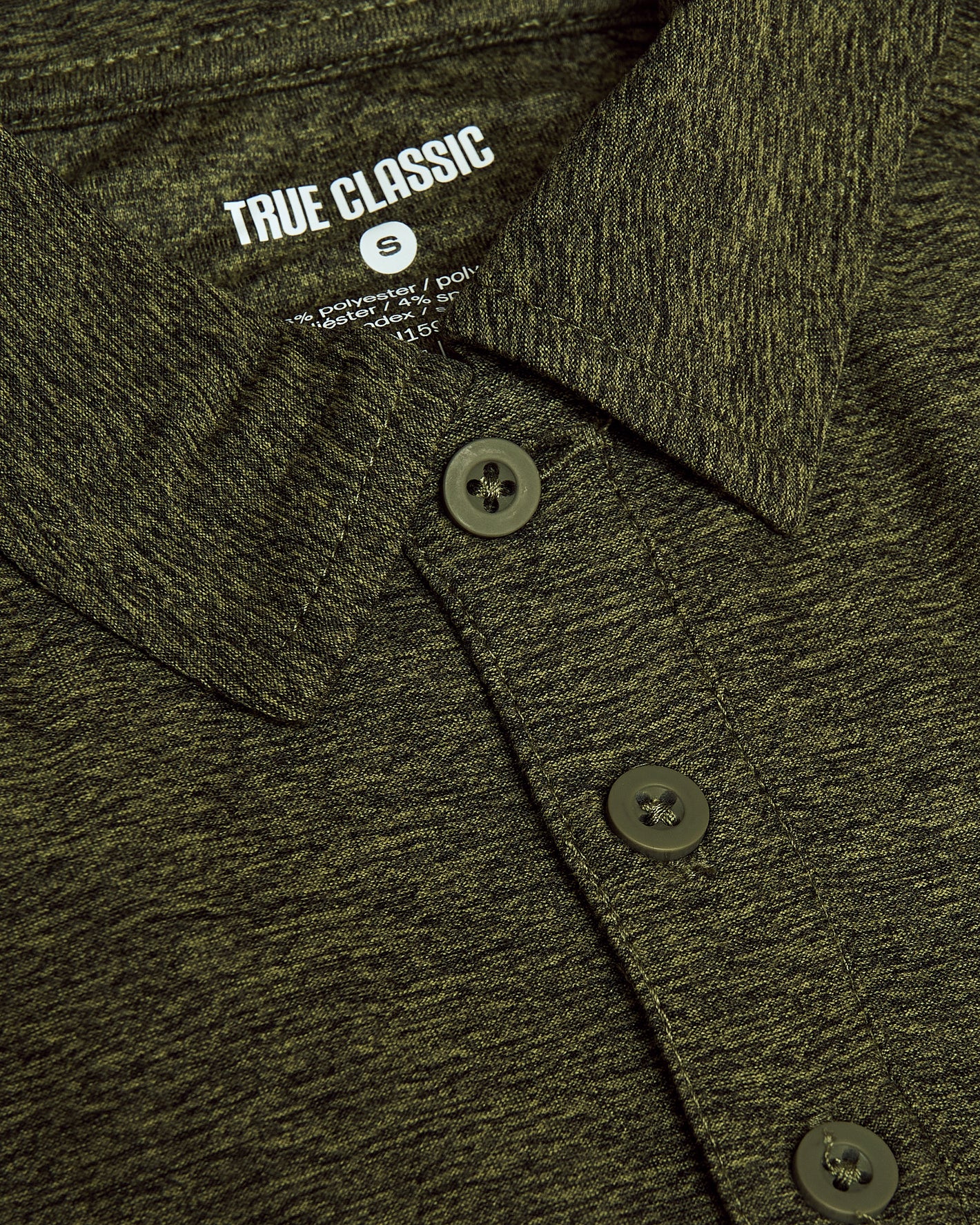 Dark Heather Pear Active Polo 2.0 close-up showing collar and buttons.