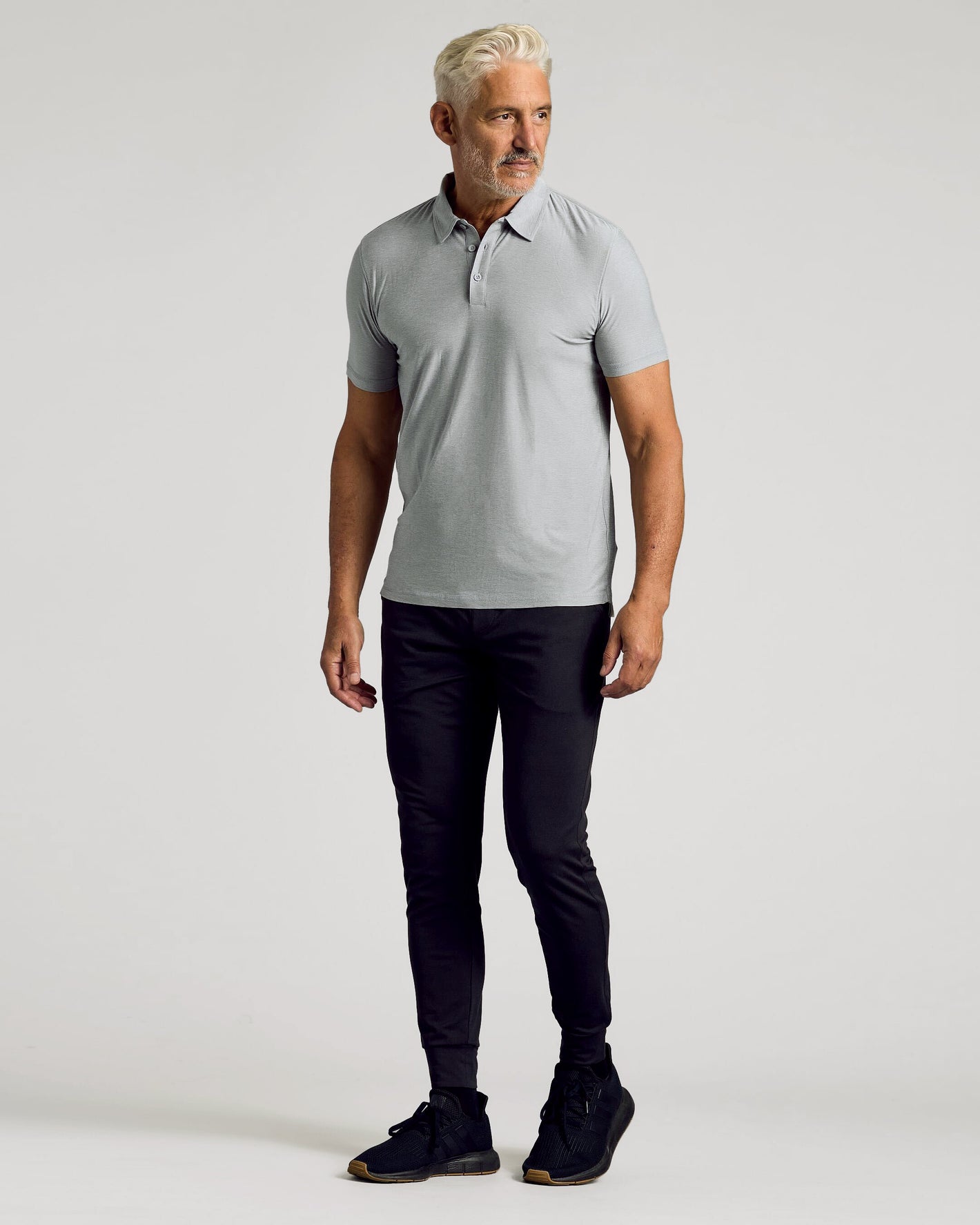 Light Heather Gray Active Polo 2.0 on man with black joggers.