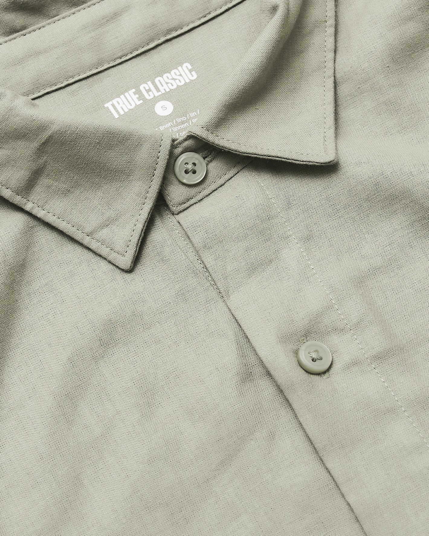 Mossy Oak Short Sleeve Linen Shirt with collar and buttons visible.