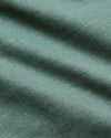 Close-up of Moss Short Sleeve Linen Shirt fabric, showcasing its soft weave texture.
