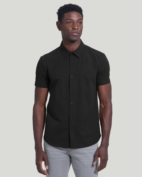 Man wearing Black Commuter Short Sleeve Shirt with light gray pants.
