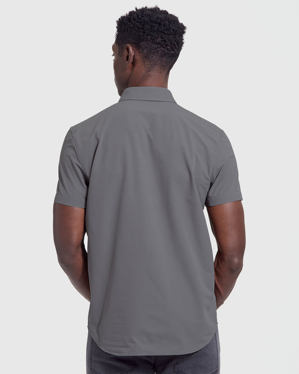 Man in Carbon Commuter Short Sleeve Shirt, back view, with charcoal jeans.