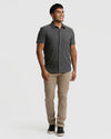 Man wearing Short Sleeve Ripstop Commuter Shirt in charcoal gray, smiling.