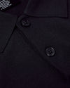 Black Dressy Polo close-up showing textured fabric, collar, and buttons.