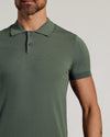 Man wearing Moss Dressy Polo with knit texture and button placket.