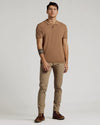 Young man modeling Truffle Dressy Polo with khaki trousers and brown boots.