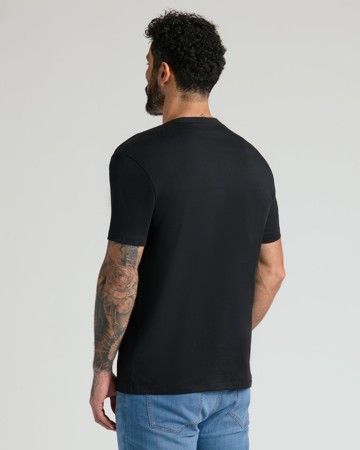 Black Premium Pima Crew Neck 7-Pack modeled from behind, showcasing fit.