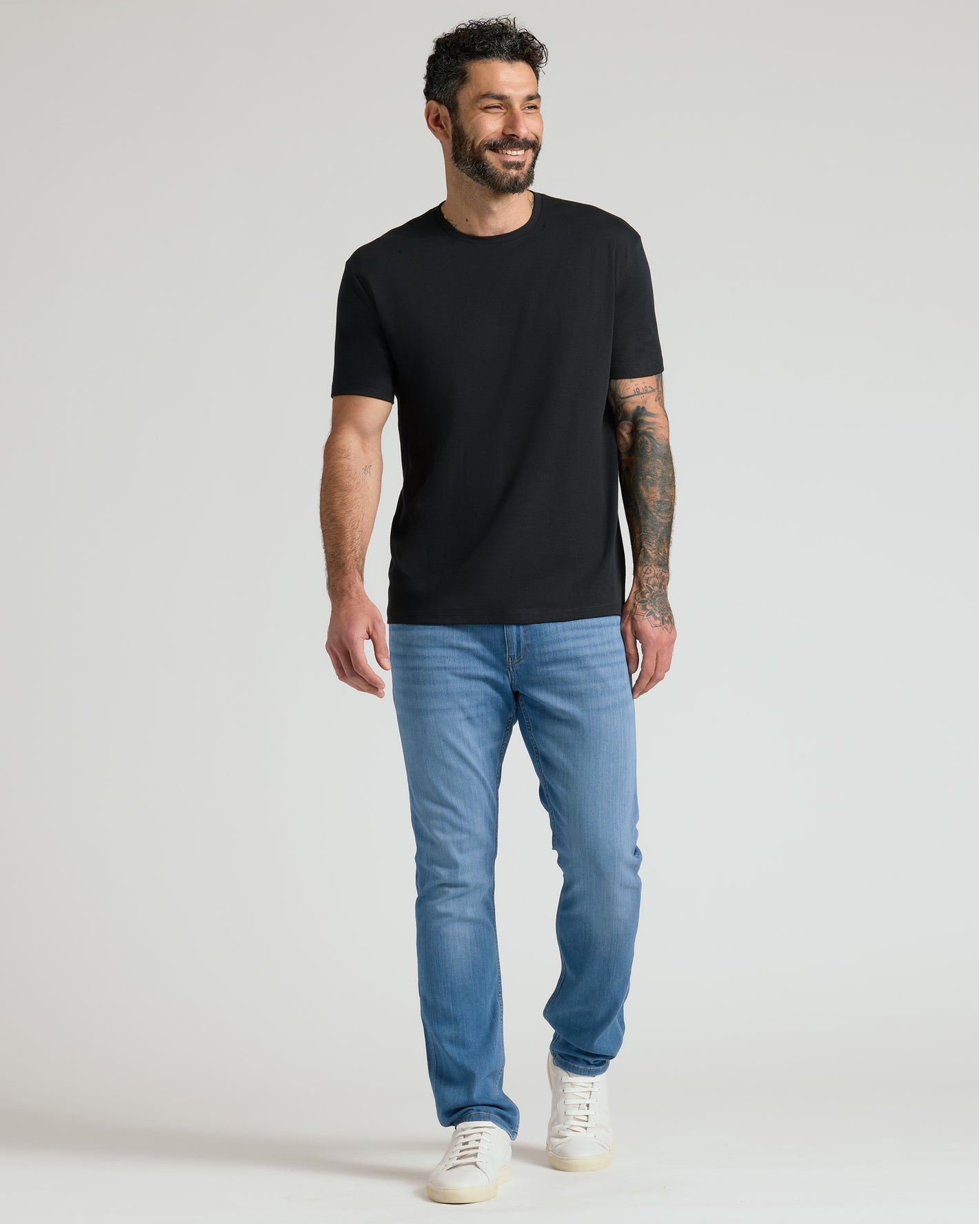 Man wearing Black Premium Pima Crew Neck, showcasing relaxed fit.