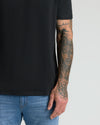 Black Premium Pima Crew Neck on tattooed arm.