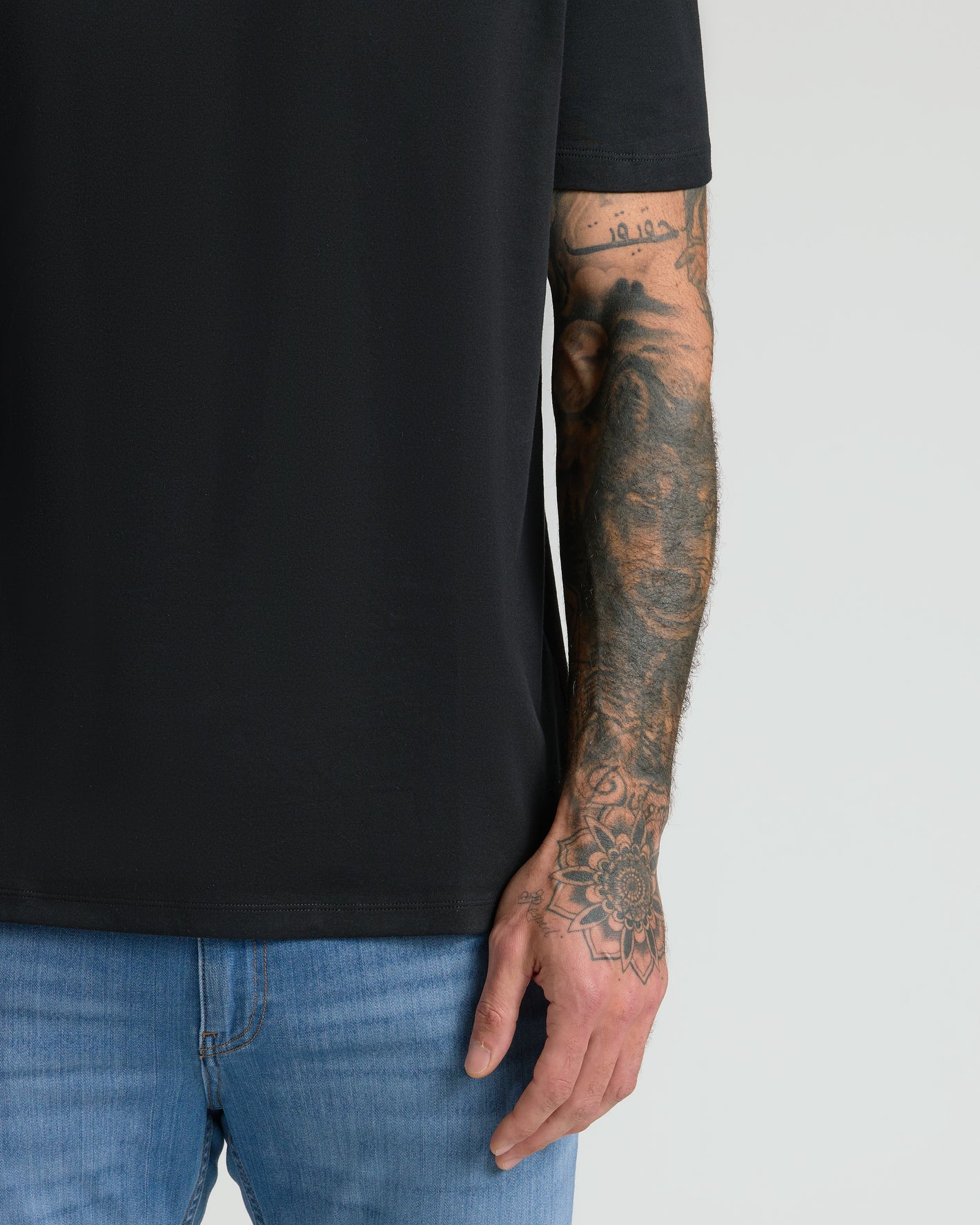 Black Premium Pima Crew Neck on tattooed arm.