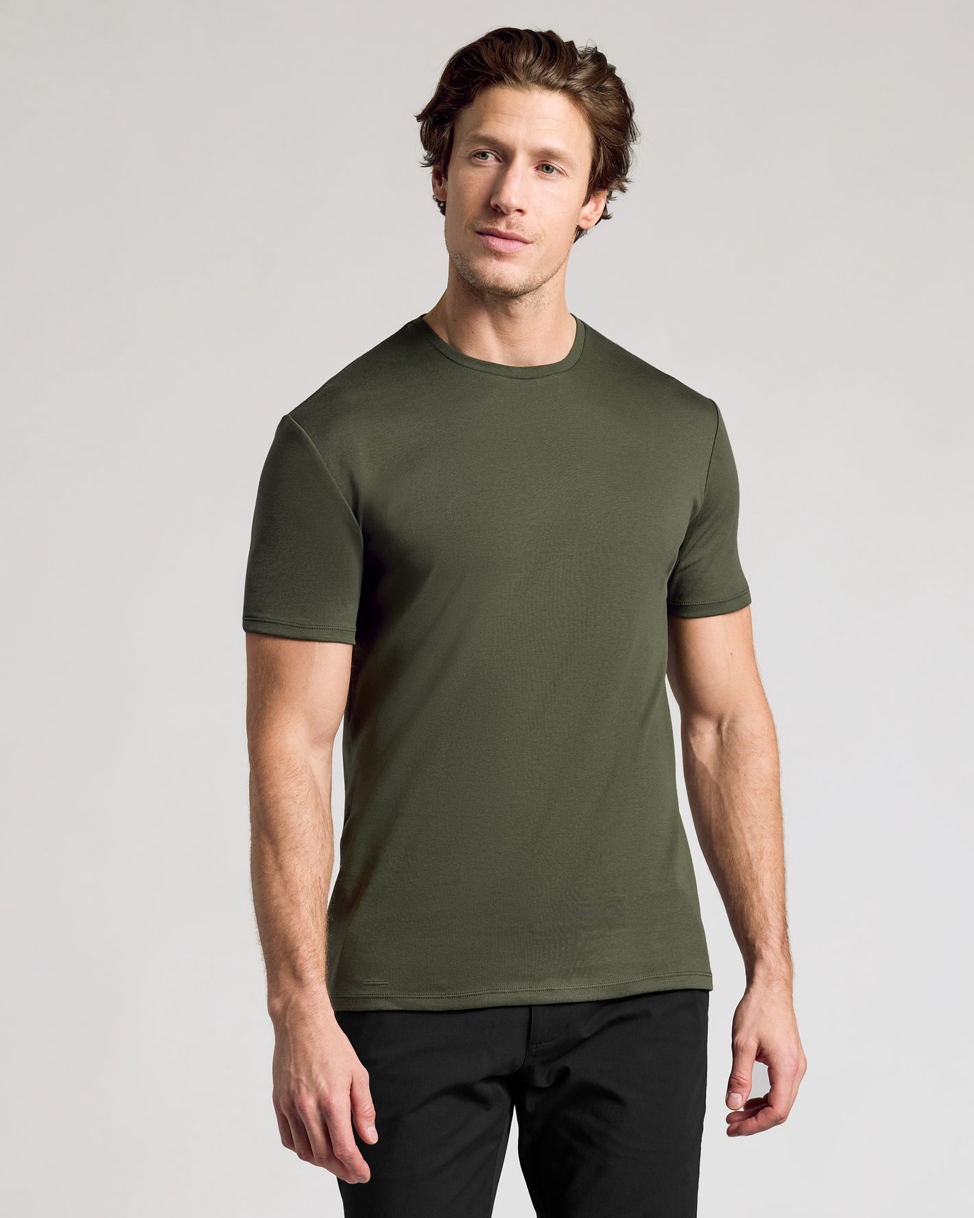 Model in Classic Premium Pima Crew 4-Pack, olive tee, black pants.