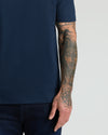 Navy Premium Pima Crew Neck worn with tattooed arm visible.
