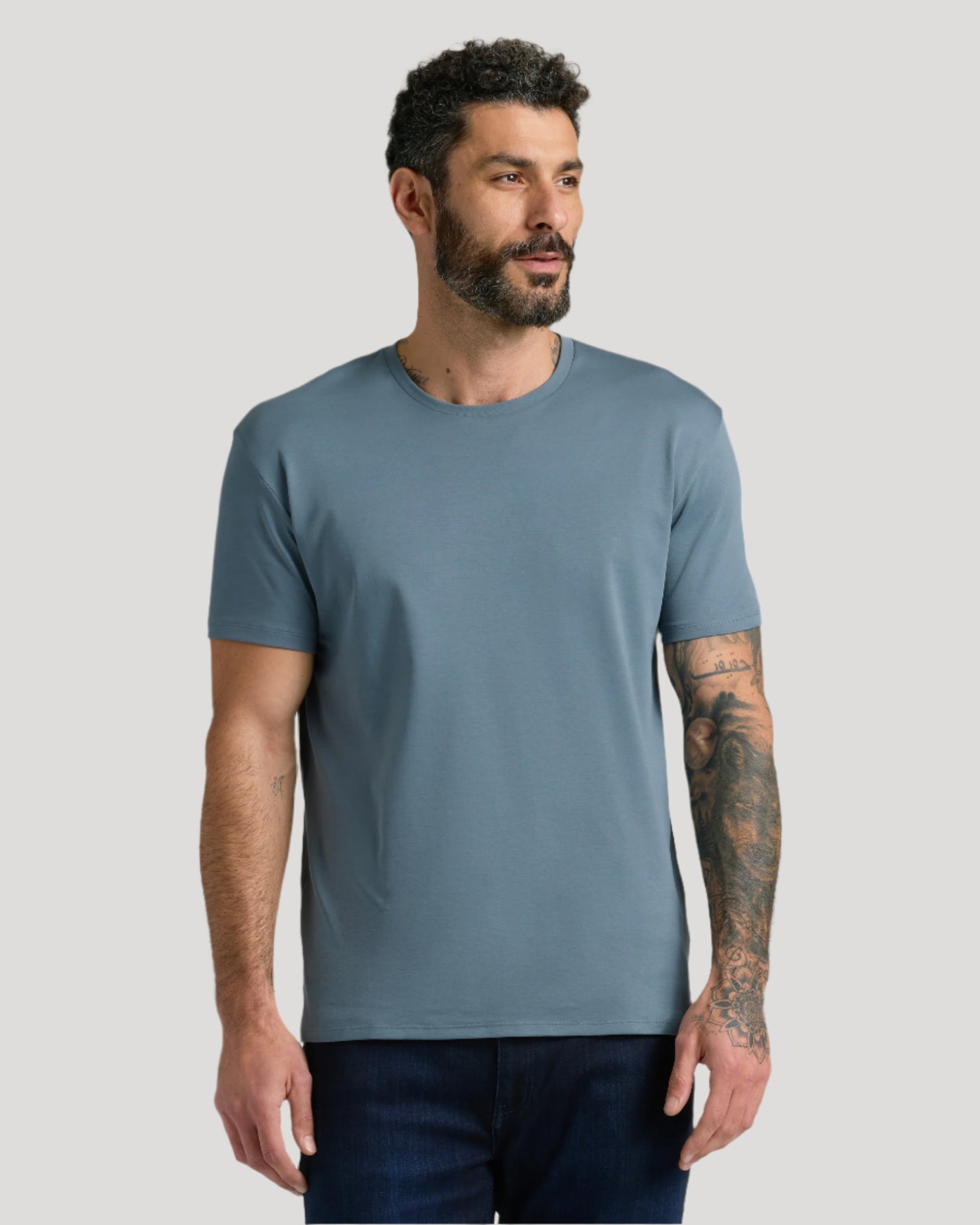 Man in Classic Wardrobe Premium Pima Tee and jeans.