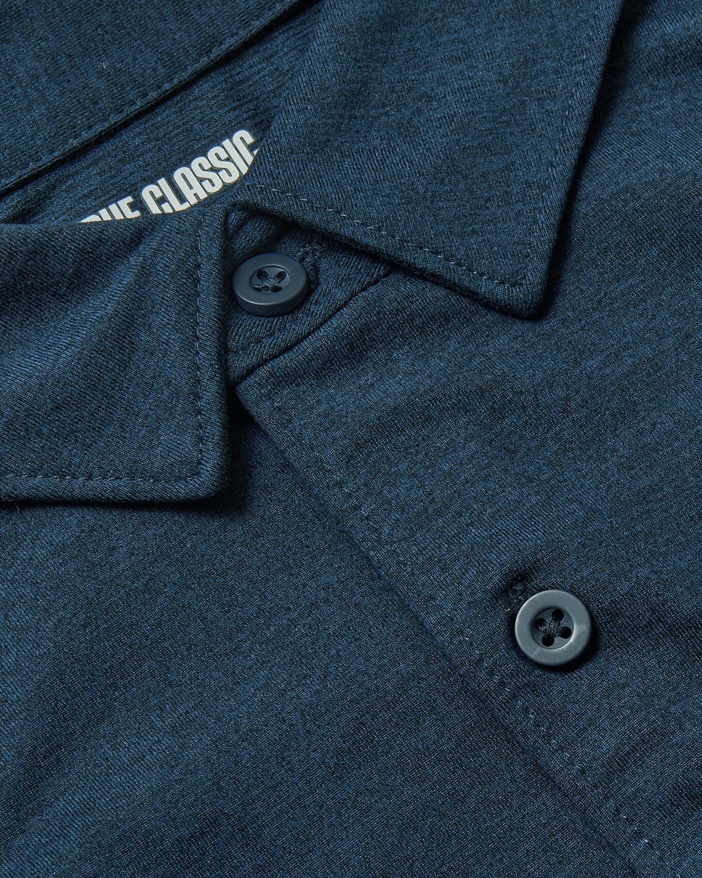 Dark Heather Navy Short Sleeve Comfort Knit Shirt with folded collar and buttons.