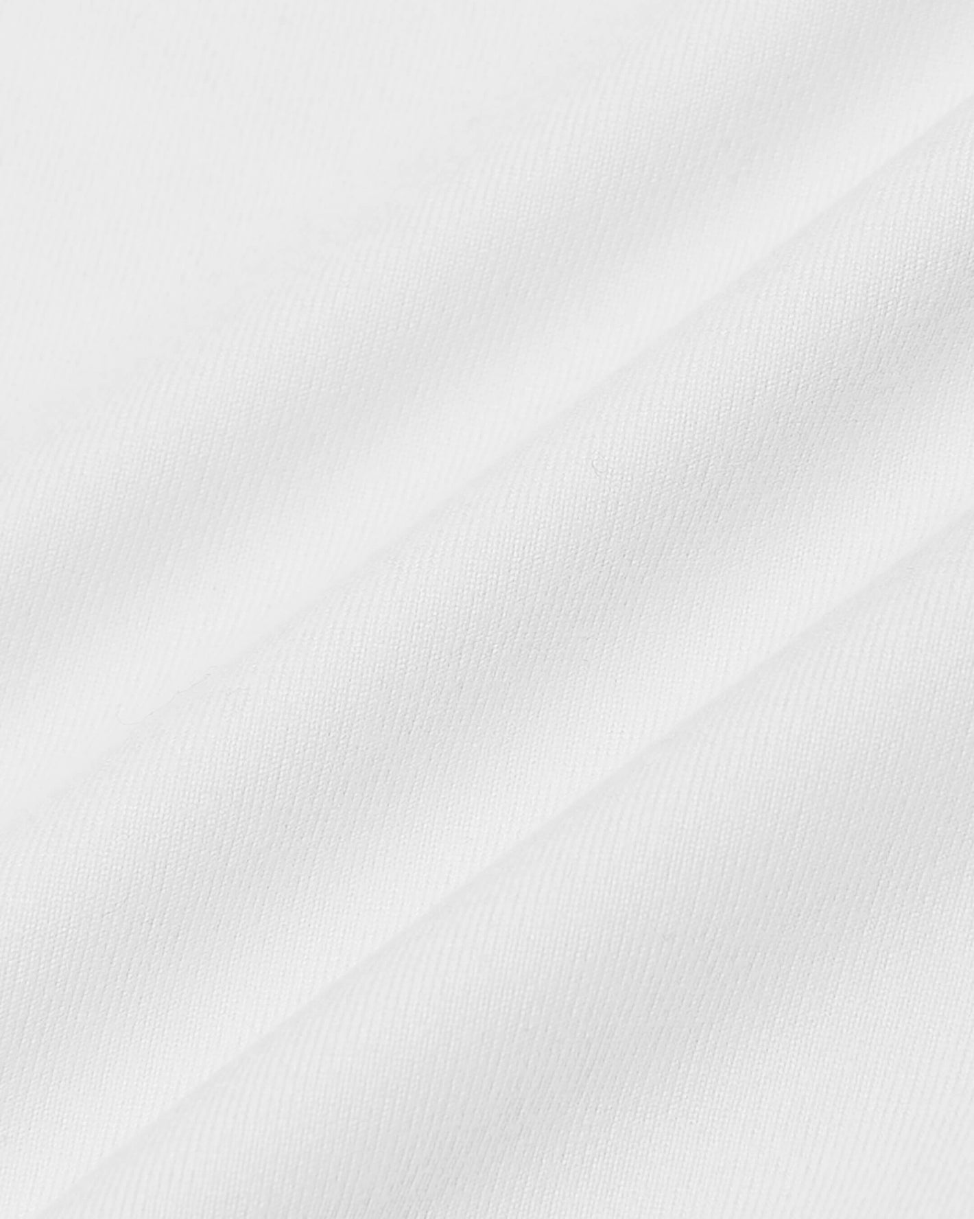 White Short Sleeve Comfort Knit Shirt with fine woven texture and soft drapes.