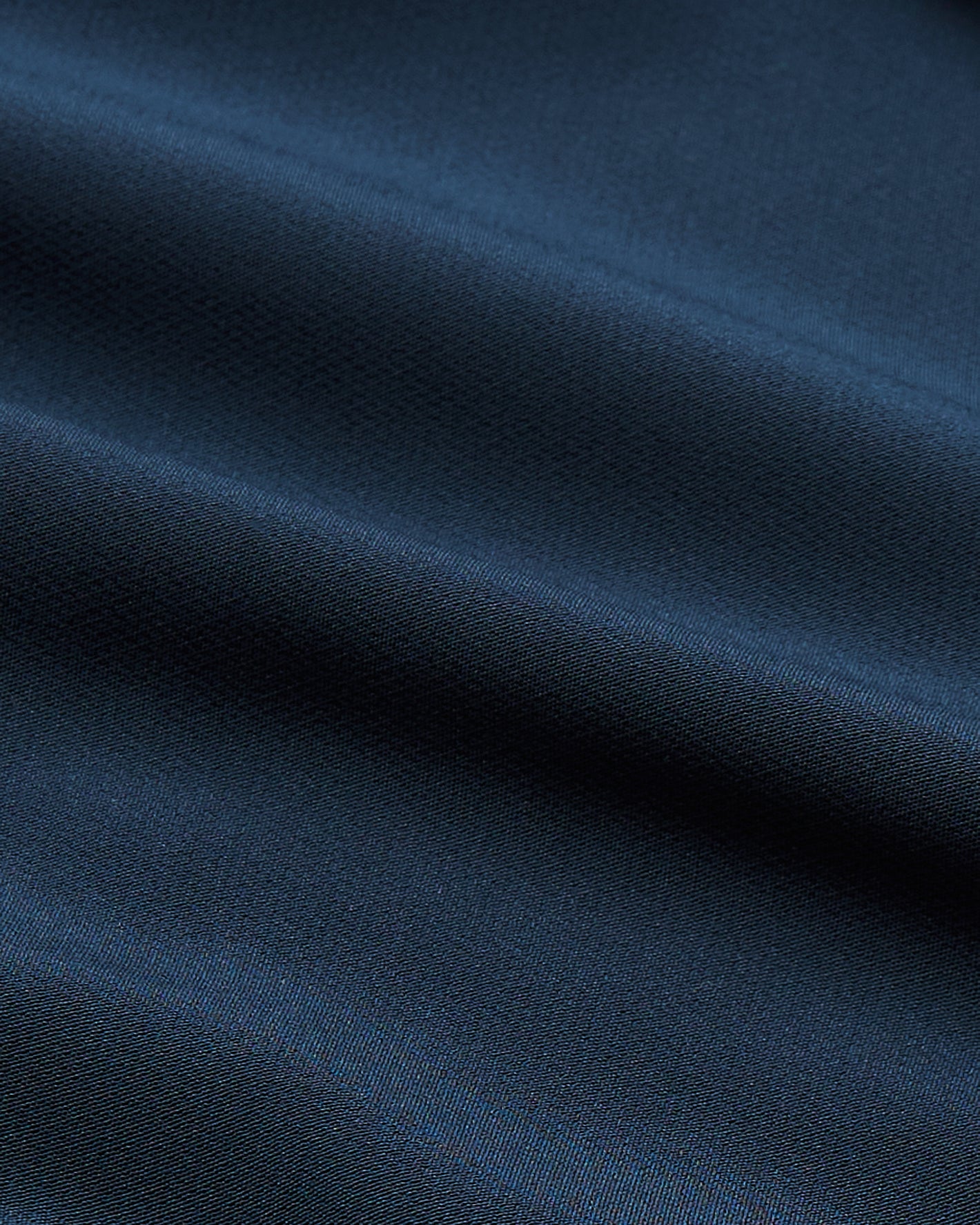 Navy Performance Dress Shirt with soft folds and fine weave.